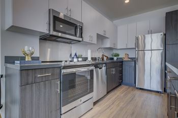 A modern kitchen with a stainless steel oven and microwave.